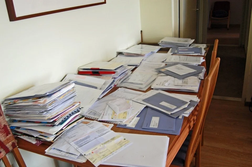 A table covered in papers and documents, from the Traces archive selection.